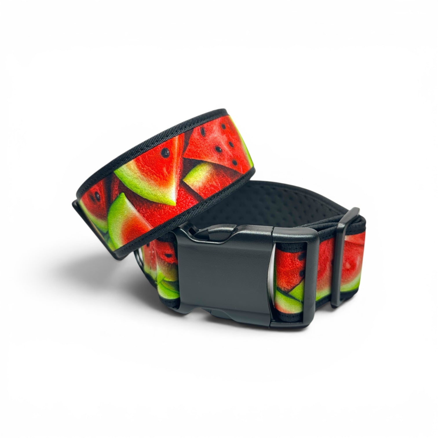 A wide black pet collar with a colorful watermelon slice pattern, featuring a matte black plastic quick-release buckle.