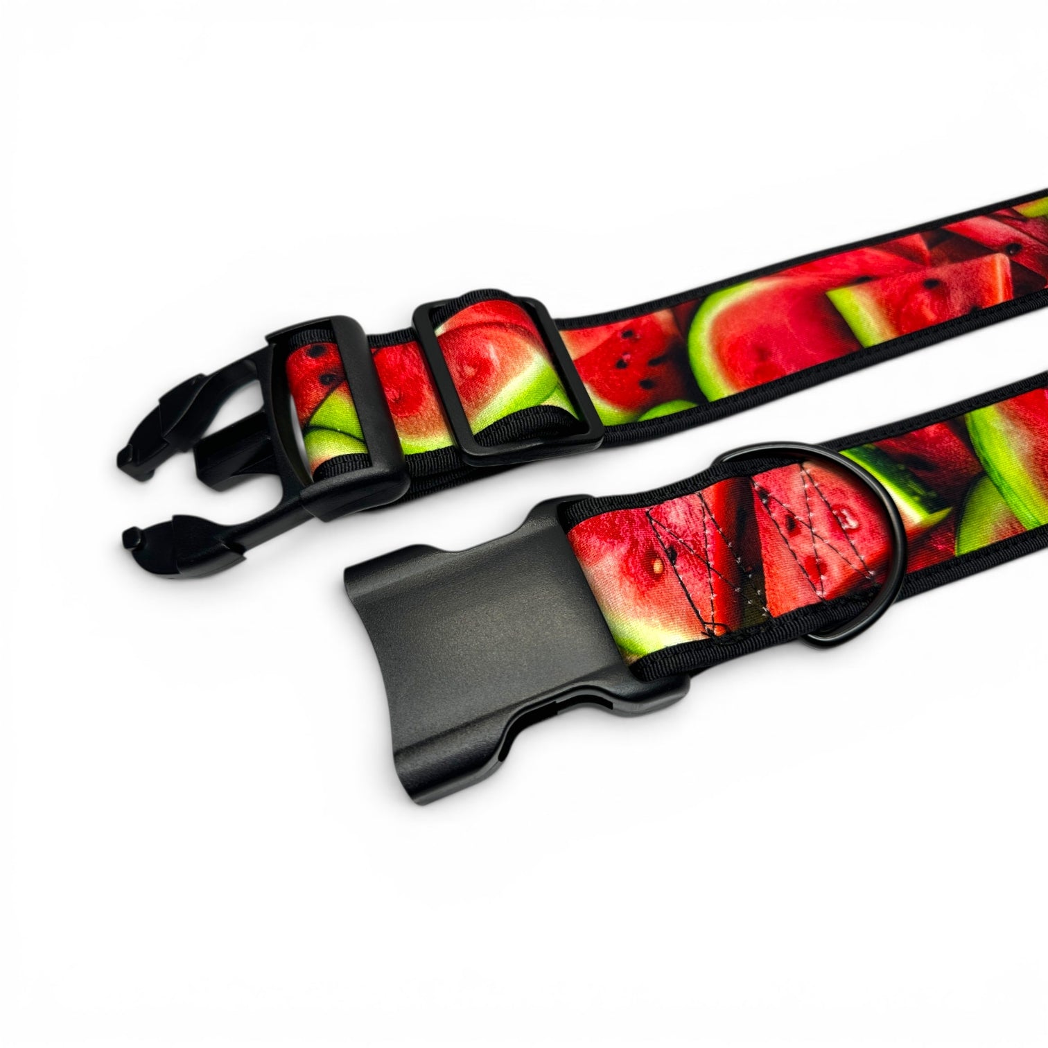 A close-up of a pet collar strap featuring a vibrant watermelon print with red, green, and black details, complete with black plastic quick-release buckles on a white background.