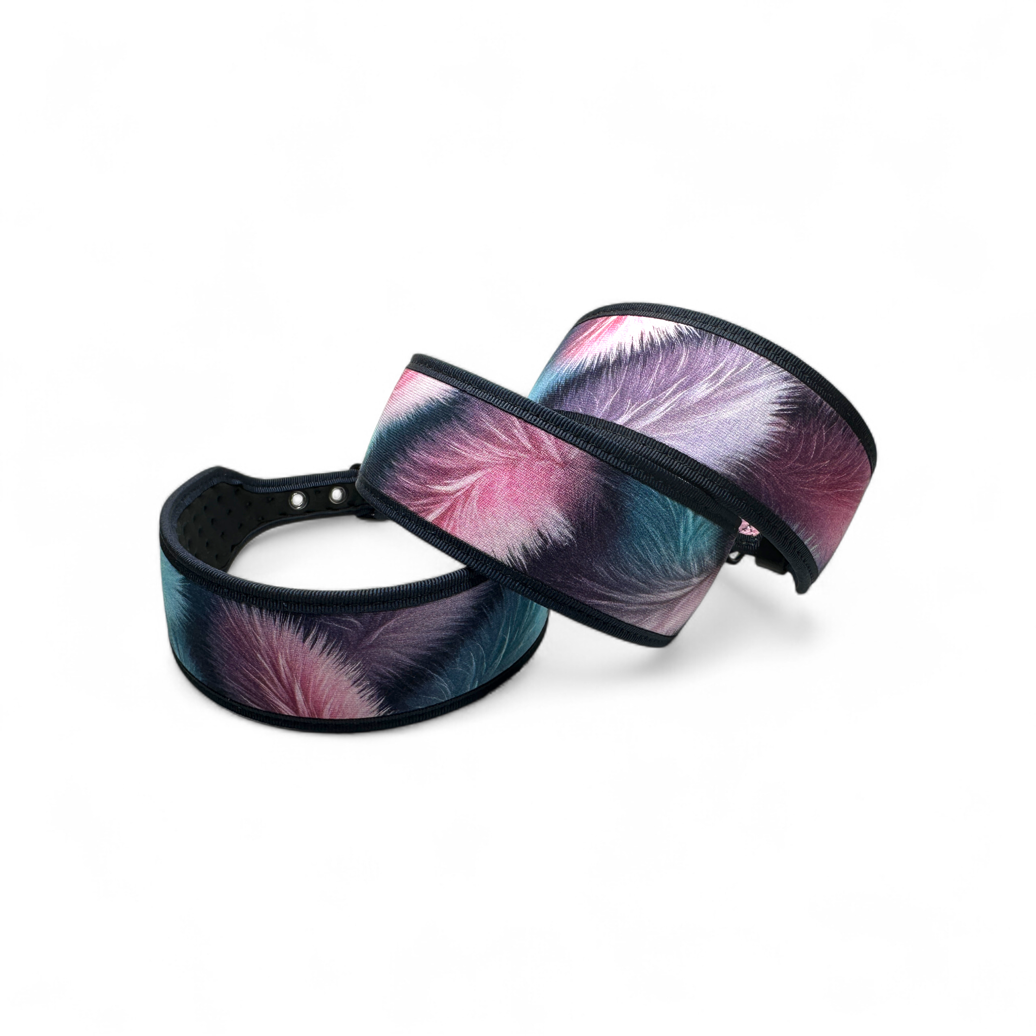 Two colorful headbands with feather design on a white background